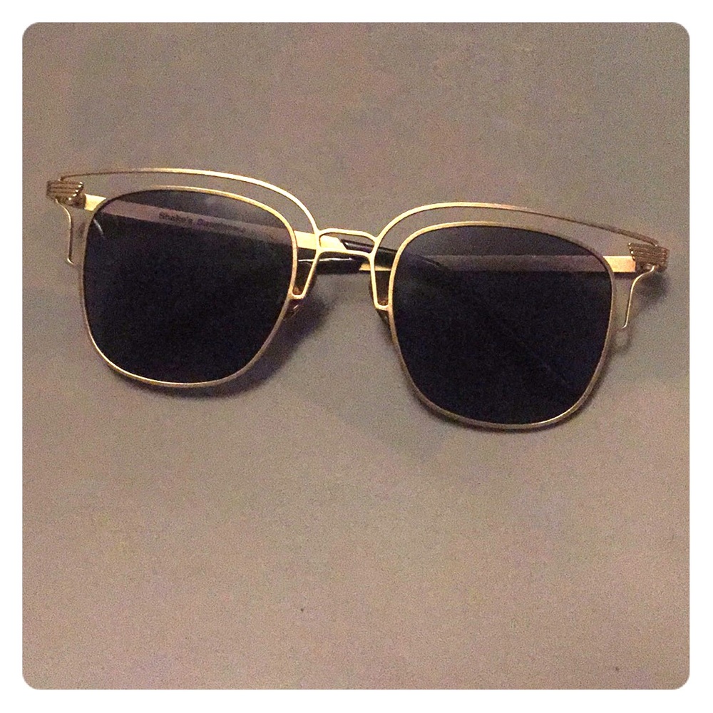 Retro style sunglasses with gold frames.